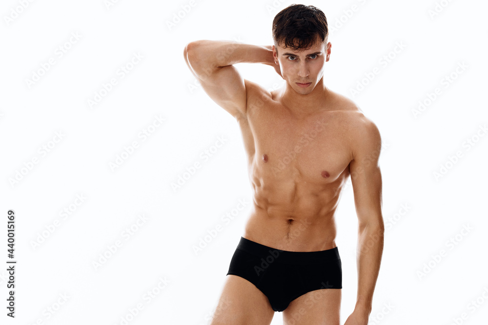 sporty man with naked muscular body in dark shorts isolated background sporty man with naked muscular body in dark shorts isolated background