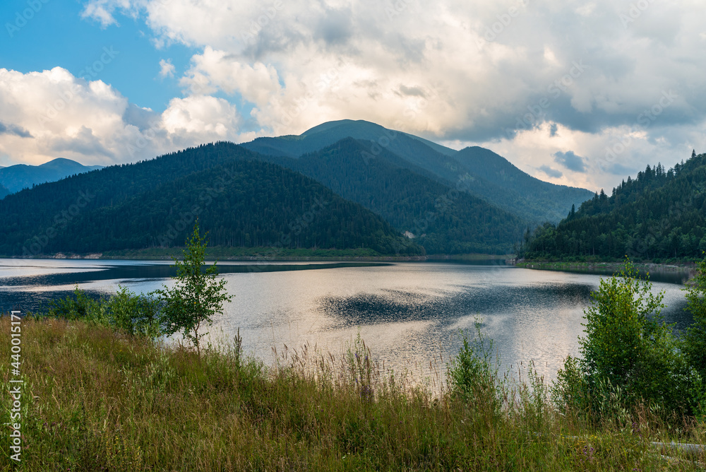 Gura Apelor lake with hills on the background in Romania