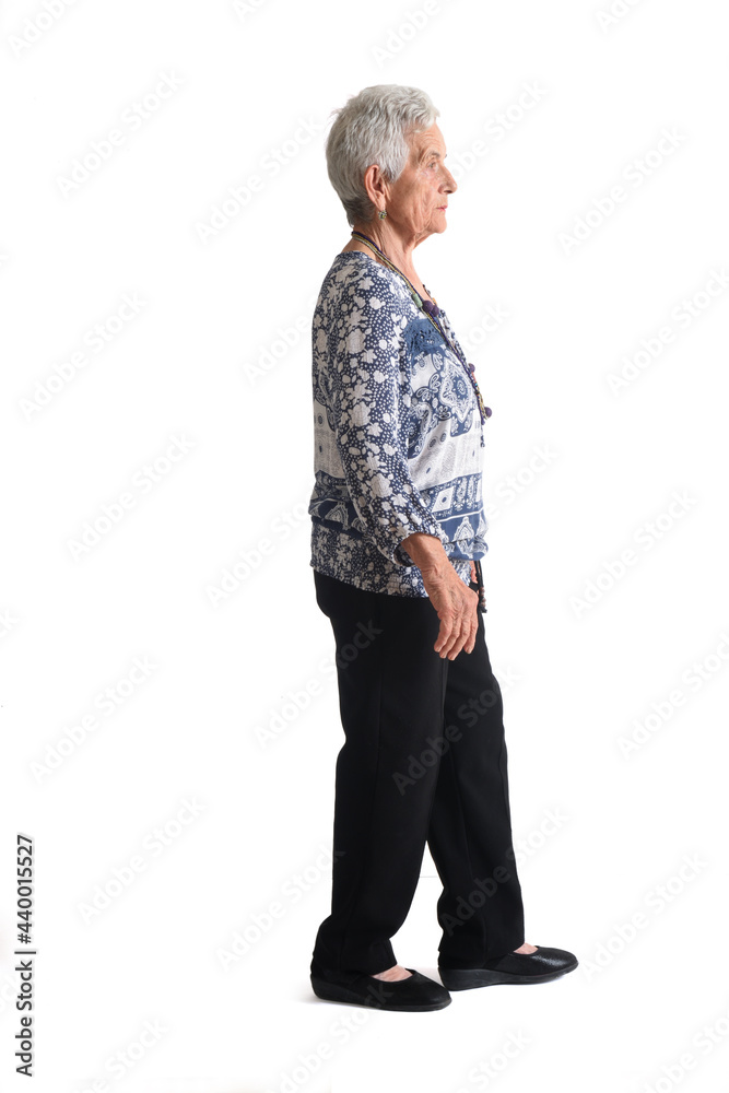 full portrait of a senior woman side view, walking on white background full portrait of a senior woman side view, walking on white background