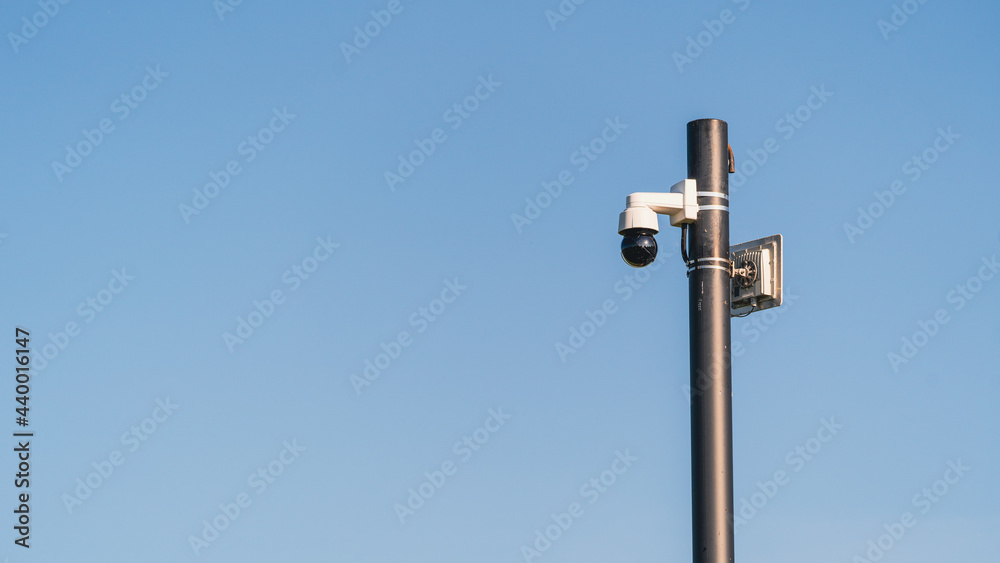 A modern wide-angle CCTV camera on a pole