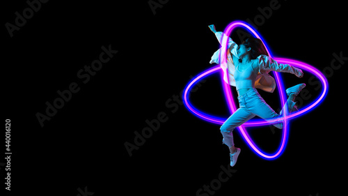 Caucasian woman's portrait on black studio background in mixed neon light. Stylish outfit. Concept of human emotions, facial expression, sales, ad, fashion. Copy space.