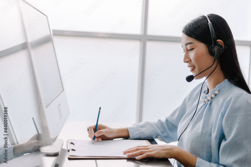 secretary operator wears a headset and microphone for consultant assistance support, the call center staff providing advice and assistance customers in smiling and happy manner secretary operator wears a headset and microphone for consultant assistance support, the call center staff providing advice and assistance customers in smiling and happy manner