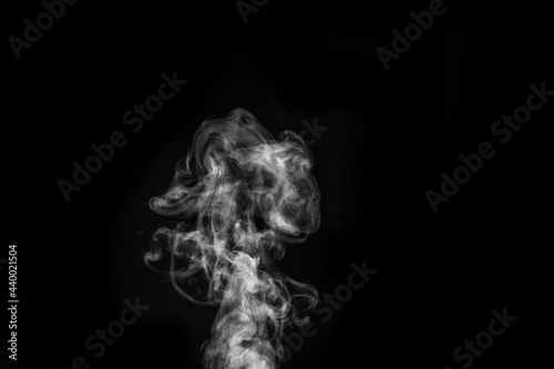Figured smoke on a dark background. Abstract background, design element, for overlay on pictures © Alena