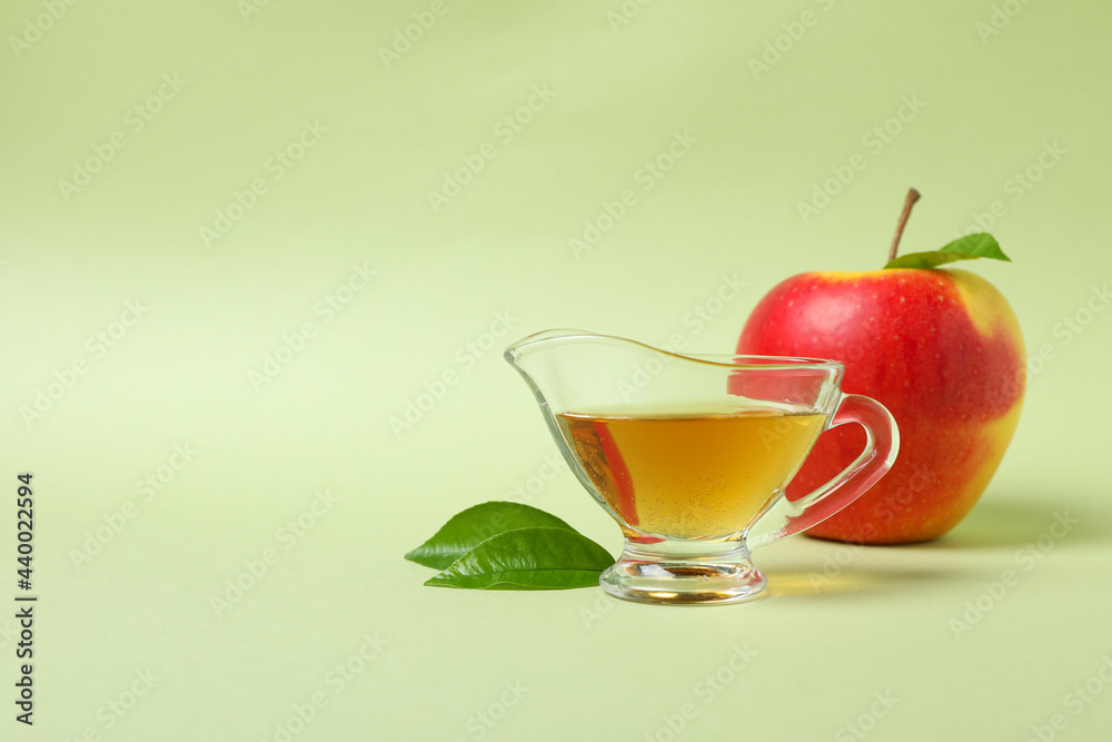 Homemade apple vinegar and ingredient on green background Homemade apple vinegar and ingredient on green background