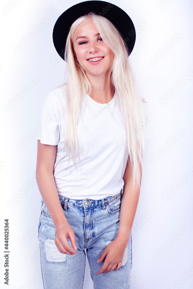 young pretty blond girl hipster in hat on white background casual close up dreaming smiling posing cheerful, lifestyle people concept young pretty blond girl hipster in hat on white background casual close up dreaming smiling posing cheerful, lifestyle people concept