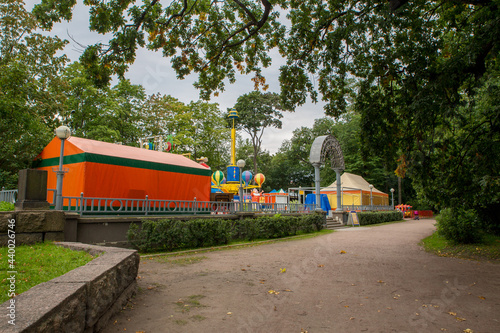 Amusement park between green trees no people