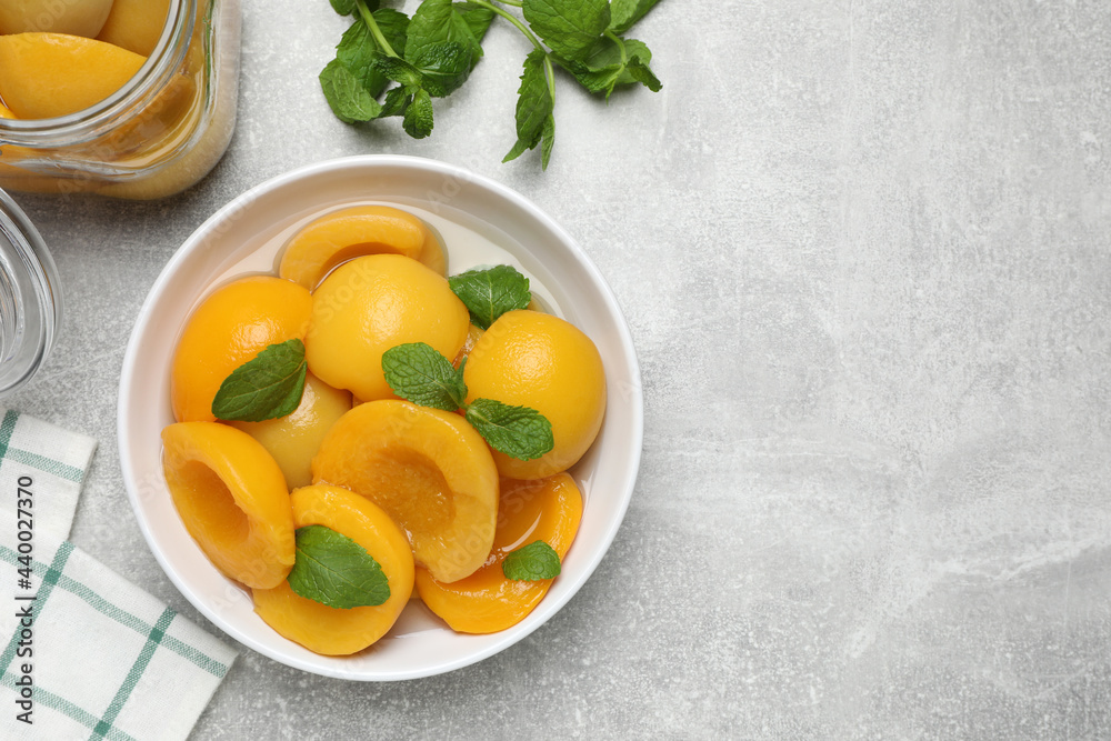 Canned peach halves on light table, flat lay. Space or text Canned peach halves on light table, flat lay. Space or text