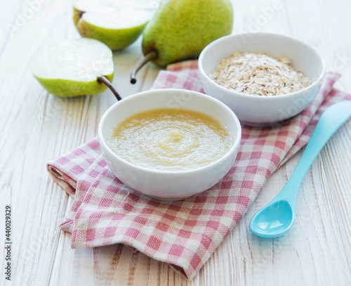 Bowl with fruit baby food and pears