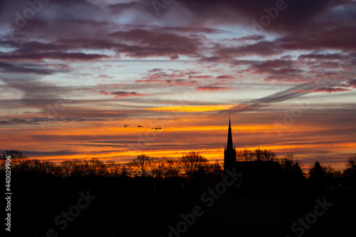 Church building exterior silhouette with a colorful sunrise sky in Province North Brabant, The Netherlands