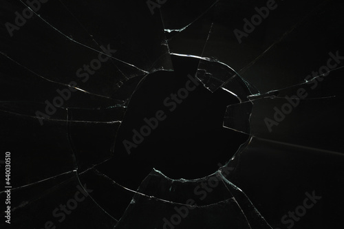 Obraz na plátne Closeup view of broken glass with cracks on black background