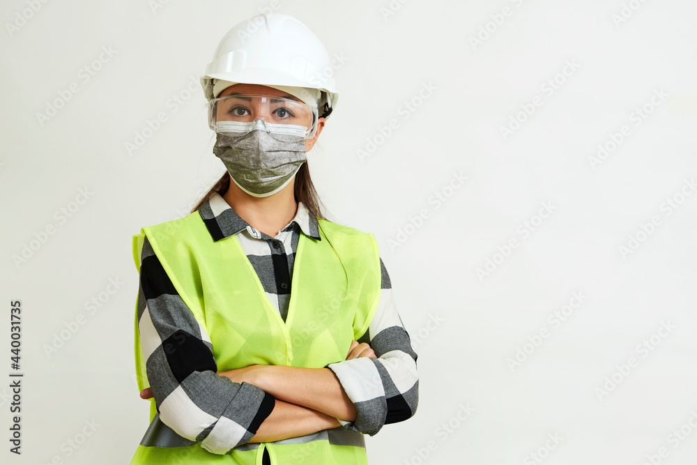 Worker woman wearing face mask and protective hard hat. Worker woman wearing face mask and protective hard hat.