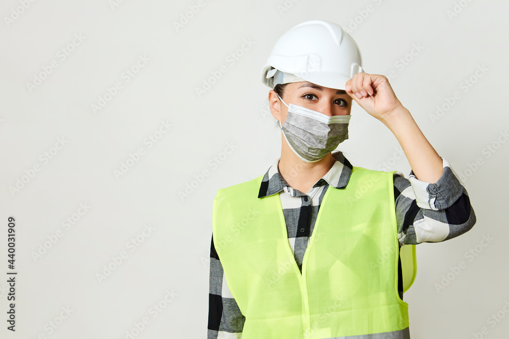 Waist up portrait of female builder with hardhat on white background Waist up portrait of female builder with hardhat on white background