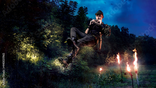 Peter Pen flies and plays the flute against the background of the forest with fairies. Cosplay on the peter foam.