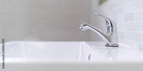 Bild auf Leinwand The bathroom faucet is turned off to save water energy and protect the environment