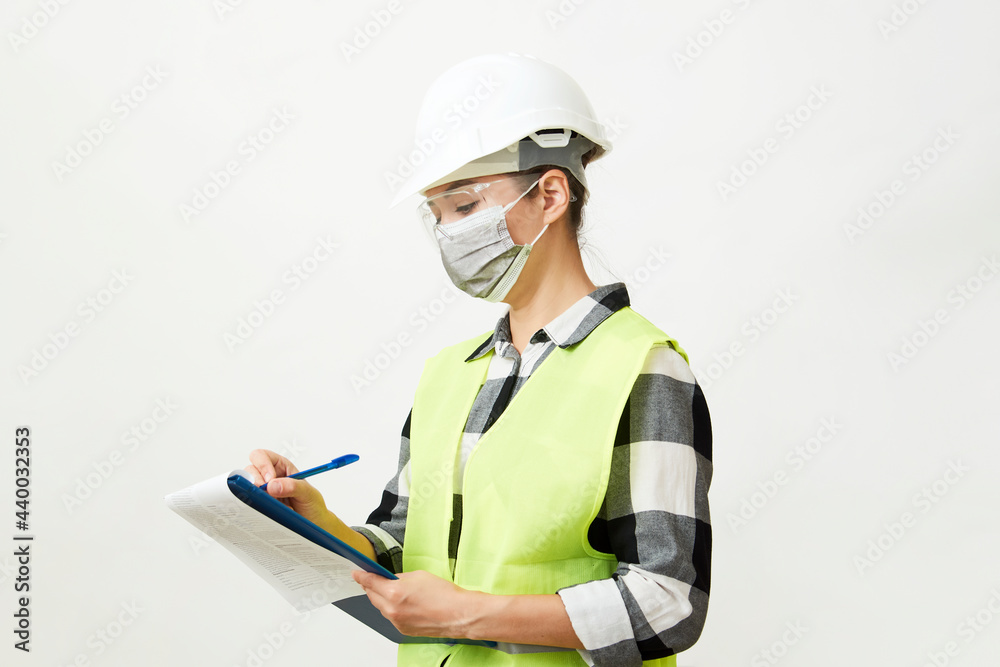Engineer woman worker with hard hat and paper clipboard Engineer woman worker with hard hat and paper clipboard