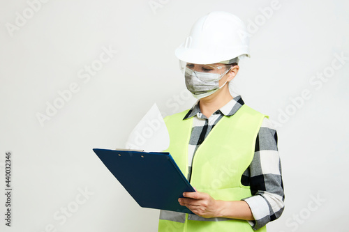 Engineer woman worker with hard hat and paper clipboard