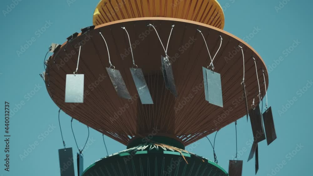 Pagan structure with glittering pieces of iron waving in the wind to