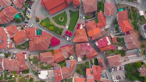 Orthodox church at old town of Ohrid, North Macedonia and village of houses with red roofs. Medieval old gothic architectures look beautiful from above sky with aerial drone 4K 30fps. 