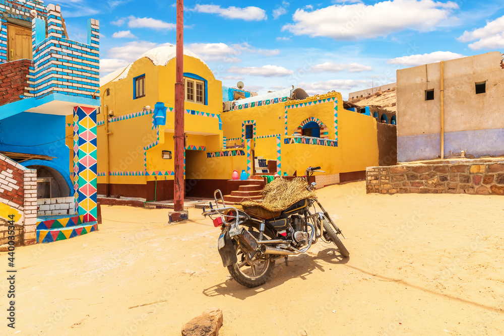Traditional Nubian village in Africa and an authentic motorbike, Egypt - obrazy, fototapety, plakaty 