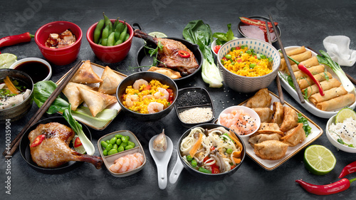 Assorted Chinese dishes and snacks on dark gray background. Traditional food concept.