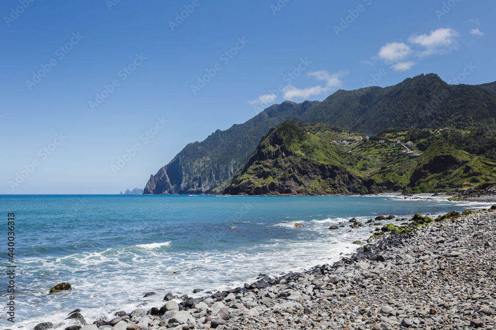 overview of Porto da Cruz basaltic beach with Larano mountains as background in Madeira island