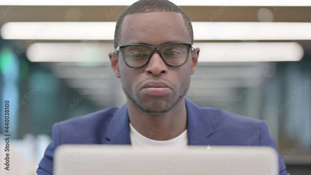 No Gesture with Head Shake by African Businessman at Work No Gesture with Head Shake by African Businessman at Work