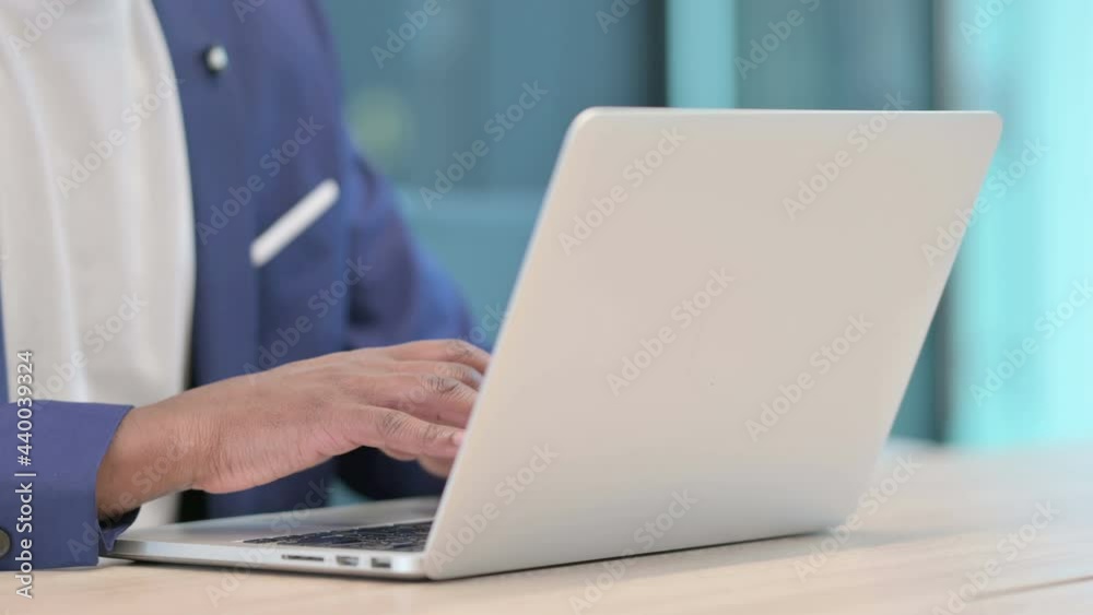 Close up of Hands of African Businessman Typing on Laptop Close up of Hands of African Businessman Typing on Laptop