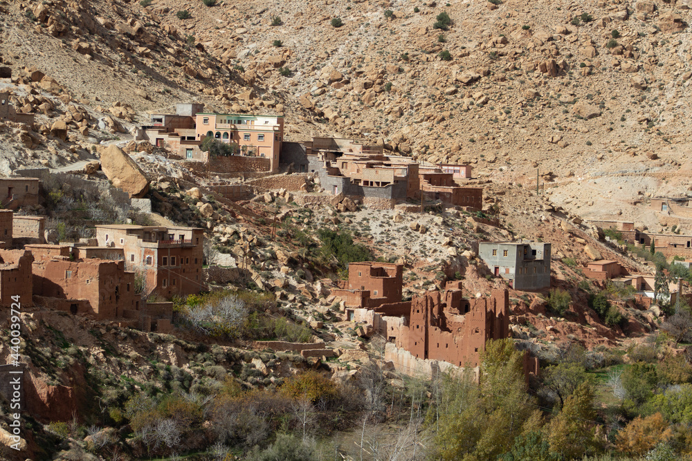mudbrick village in the High Atlas mountains with trees in the foreground