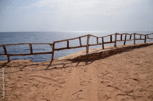 Wooden fence on beach and red sea