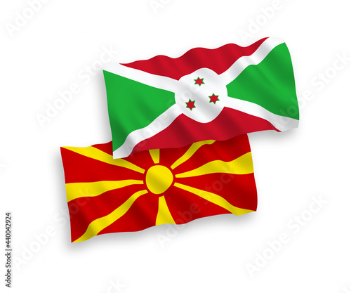 National vector fabric wave flags of Burundi and North Macedonia isolated on white background. 1 to 2 proportion.