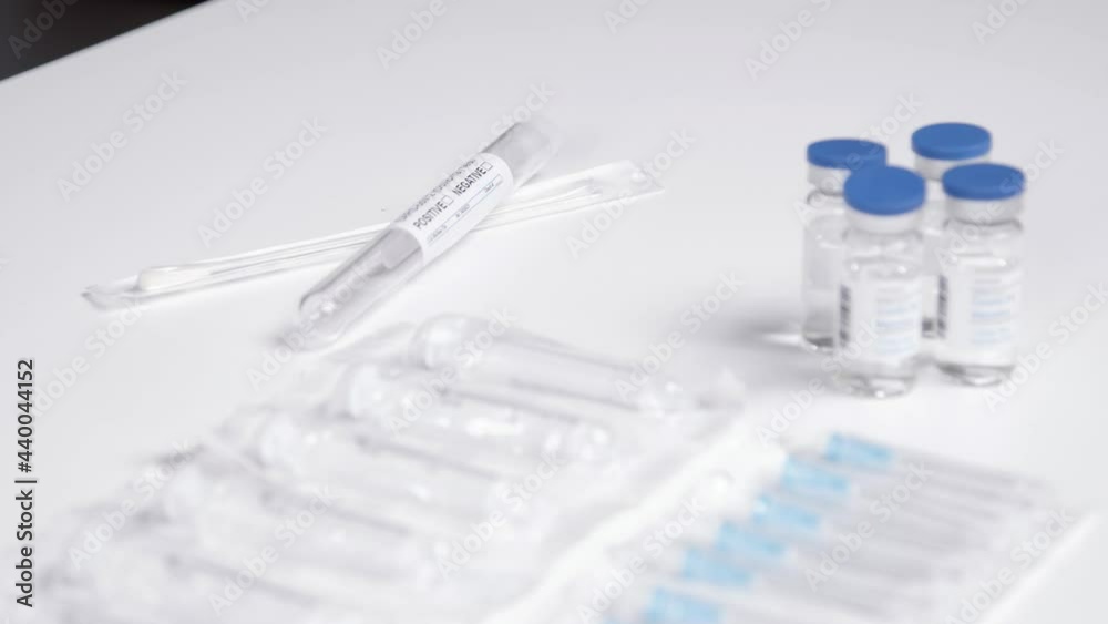 Tracking Shot Passing Over Table with Covid 19 Vaccine Medical Items Tracking Shot Passing Over Table with Covid 19 Vaccine Medical Items