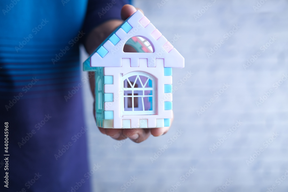 the concept of finance concept , man holding house in hand the concept of finance concept , man holding house in hand