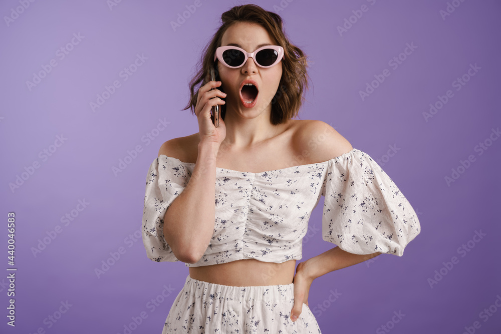 Happy young white woman holding mobile phone
