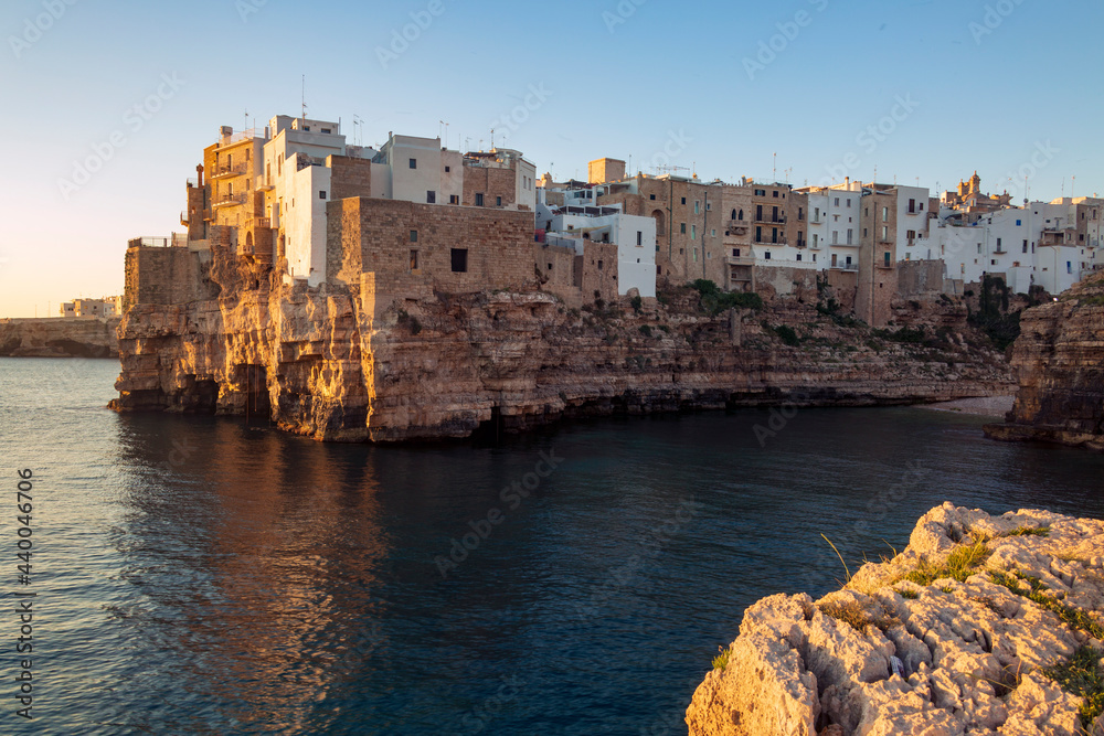 Aerial view of a sunrise in Polinano by sea. A seaside village in Bari, Puglia