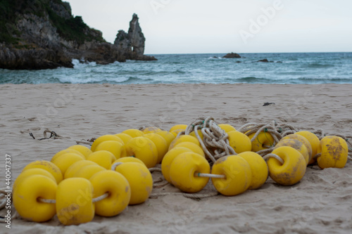 Closeup shot of a yellow buoyancy string on a beach photo