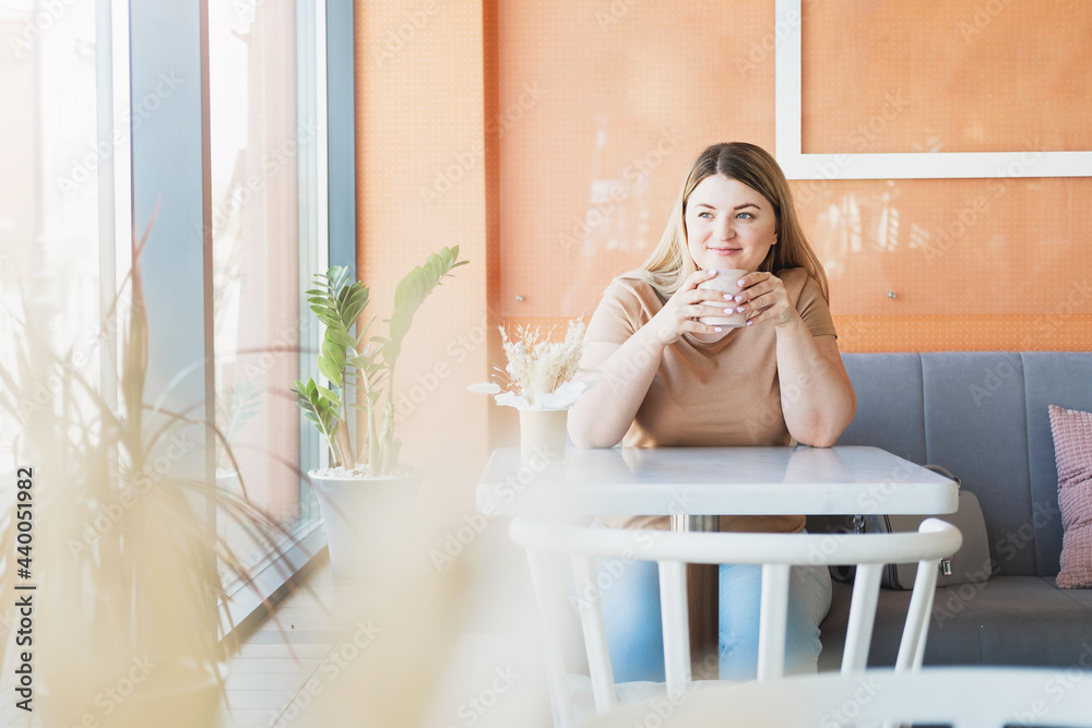 Beautiful woman resting in a cafe with a cup of coffee
