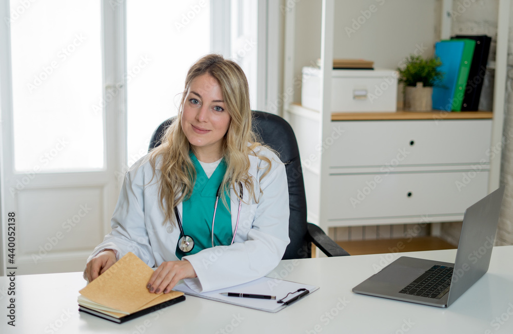 Female doctor working feeling up prescription and medical records with clipboard and laptop office Female doctor working feeling up prescription and medical records with clipboard and laptop office