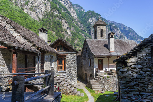 The tradtional stone houses with church tower in the beautiful village of Foroglio, Ticino, Switzerland photo