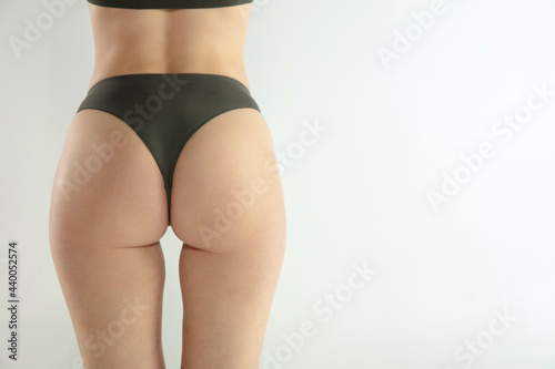 Girl's buttocks isolated in white. The fitness, diet, sports, plastic surgery and aesthetic cosmetology concept. Back view