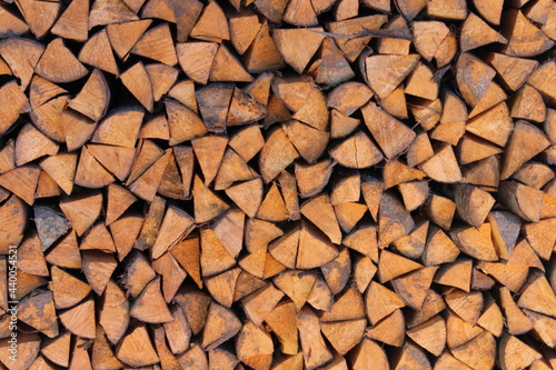 Pine firewood. Brown wood background.