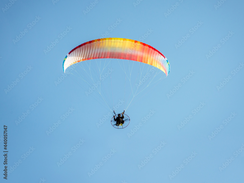 Motor Para glider greeting to earth fromm blue sky Motor Para glider greeting to earth fromm blue sky