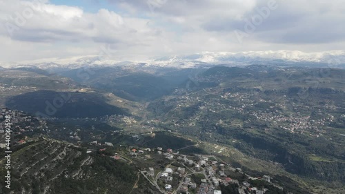 Drone shot showing Lebanese villages and snowy mountains photo