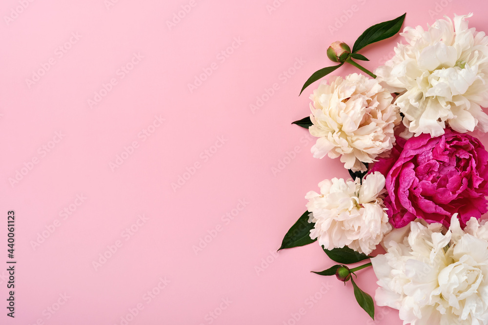 Beautiful red, pink and white peony flowers bouquet over pink background, top view, copy space, flat-lay. Valentines, Wedding and Mothers day background.