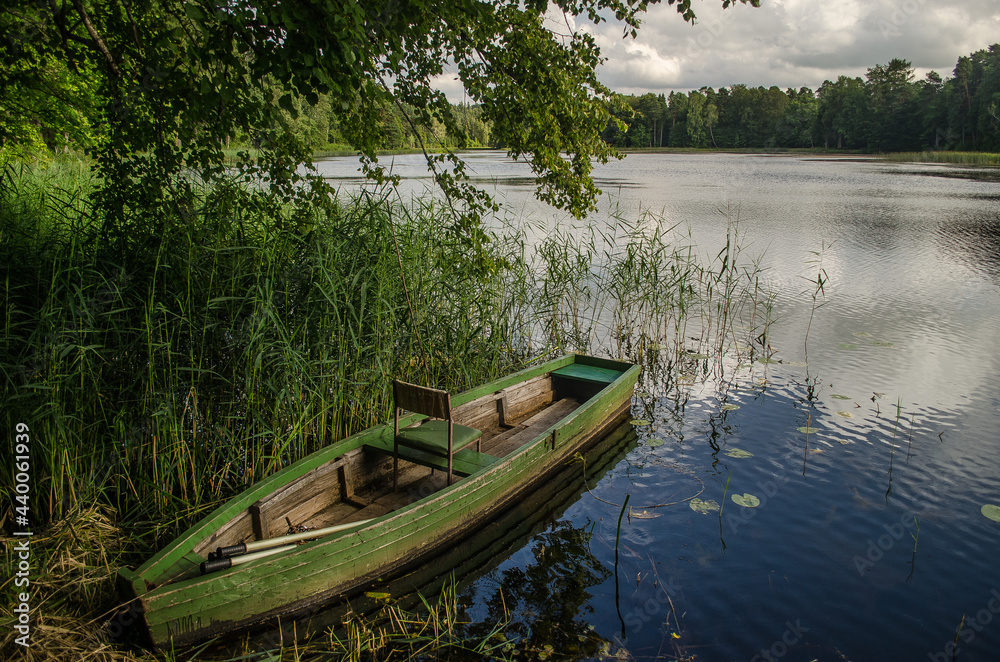 Boat in Kazdanga village mill lake, Latvia.