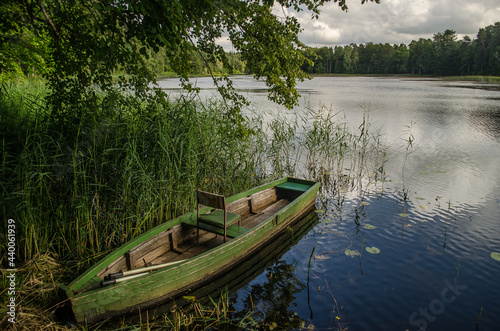 Fototapeta Naklejka Na Ścianę i Meble -  Boat in Kazdanga village mill lake, Latvia.