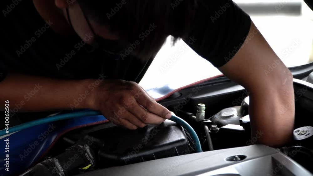Asian mechanic checking car air conditioning system,Servicing car air conditioner.
Asian mechanic checking car air conditioning system,Servicing car air conditioner.