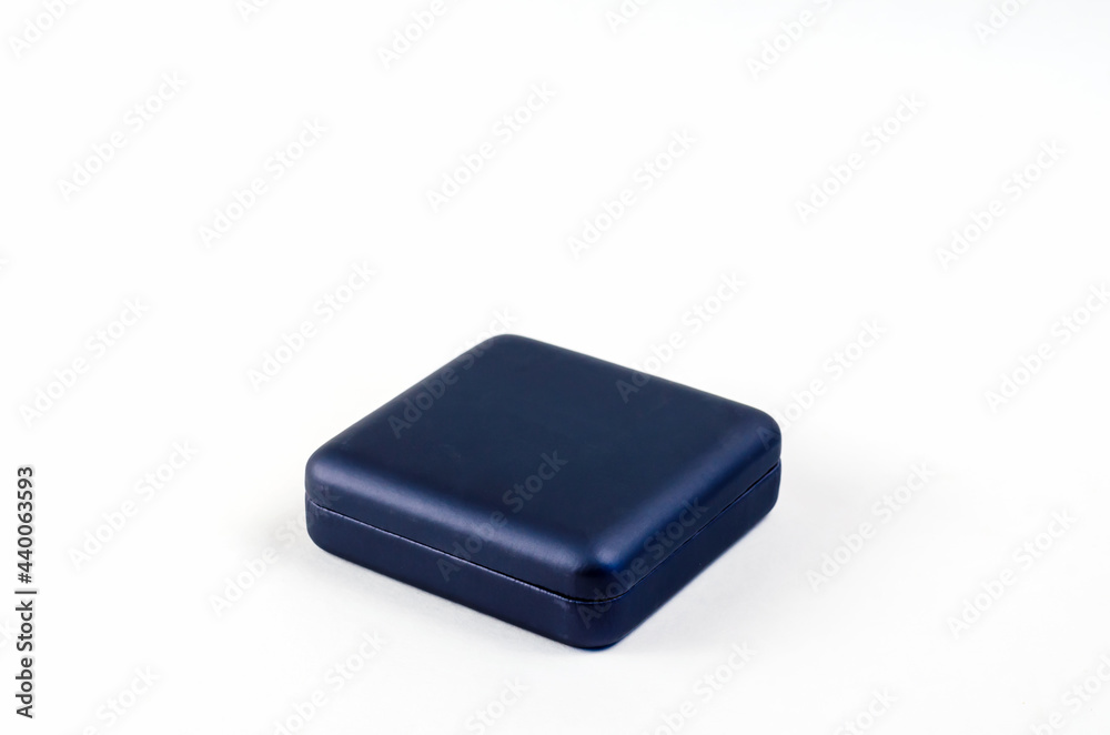 Small Square plastic gift box on white background. Closed blue box for rings, earrings, cufflinks and other jewelry Small Square plastic gift box on white background. Closed blue box for rings, earrings, cufflinks and other jewelry
