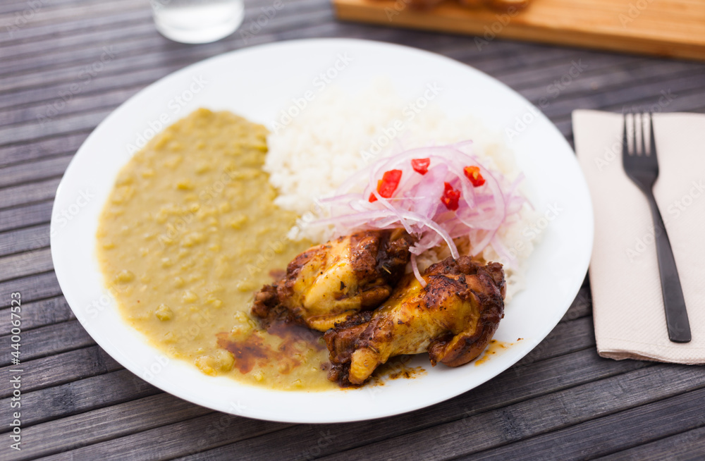 traditional Peruvian dish. chicken wings with pea puree, rice and pickled onions traditional Peruvian dish. chicken wings with pea puree, rice and pickled onions