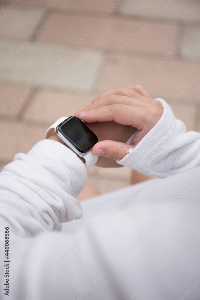 Asian Pregnant Woman using smart watch outdoor 