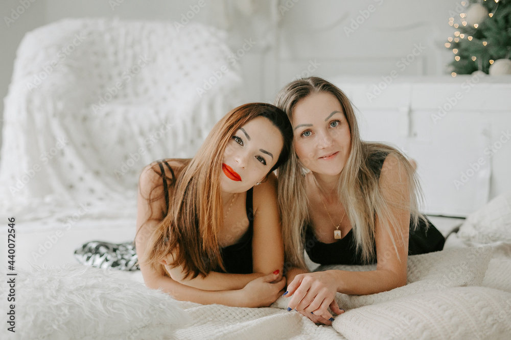 Front view of two beautiful young women lying on the floor and looking at camera. Front view of two beautiful young women lying on the floor and looking at camera.